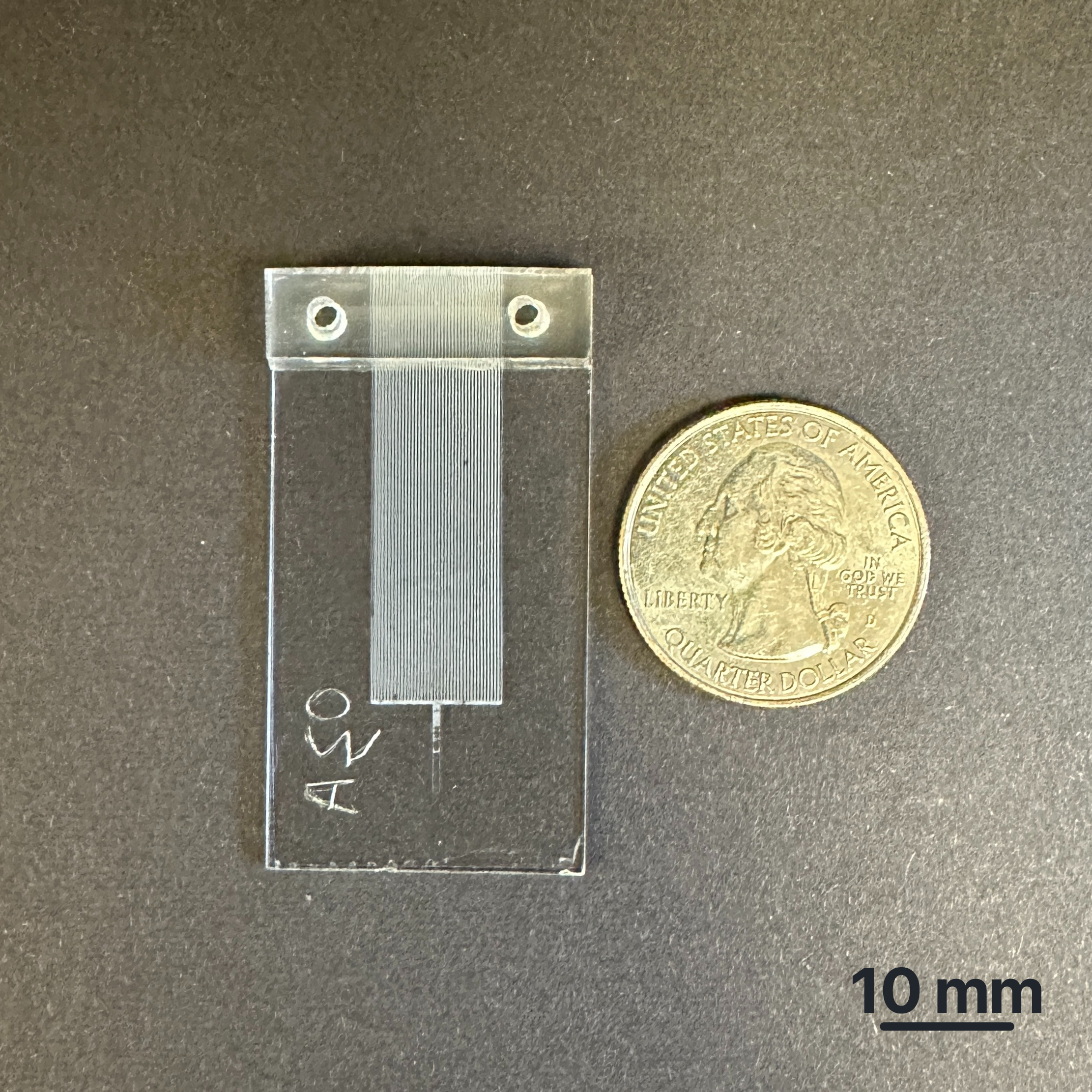 picoTLC device beside a US quarter for scale